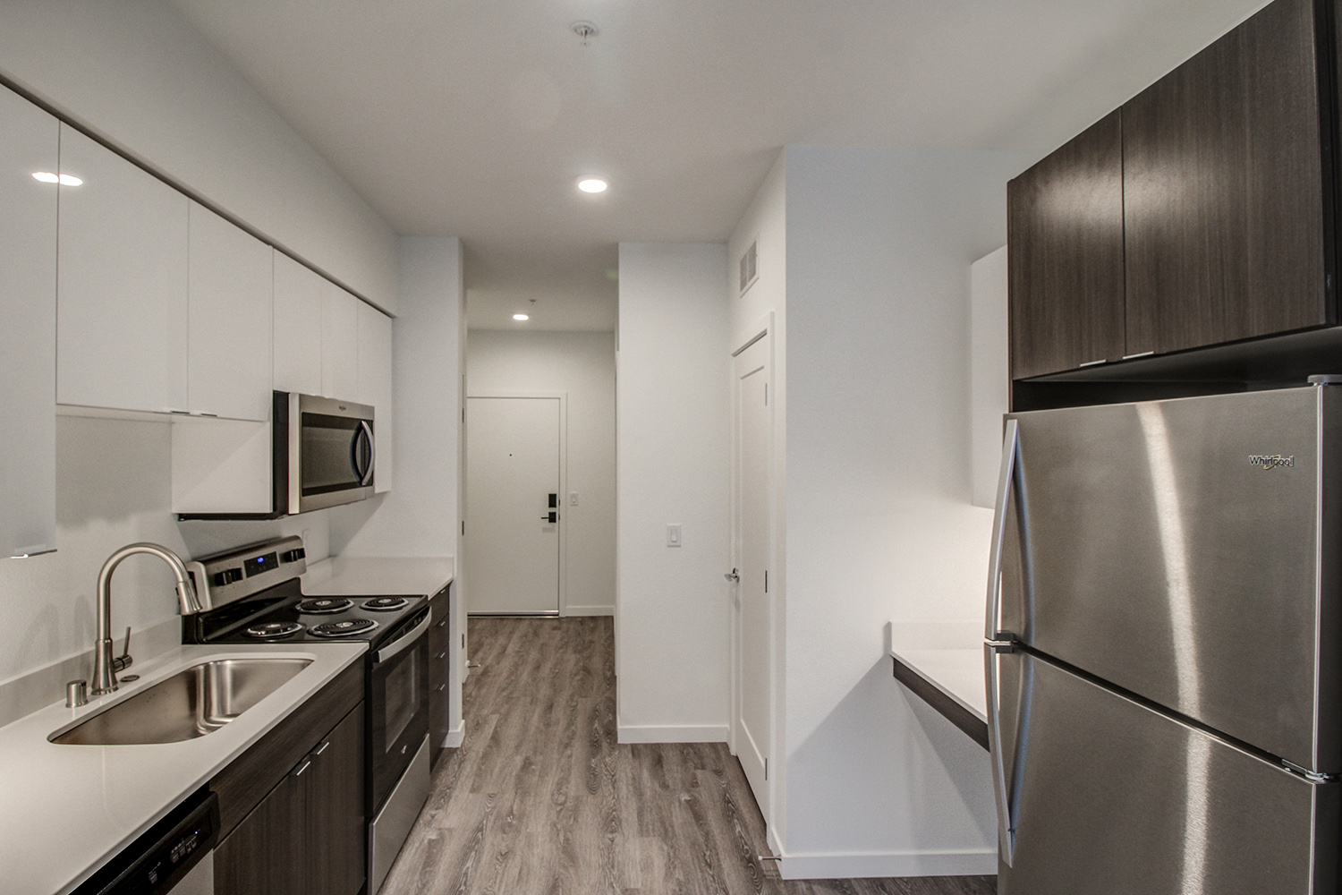 Kitchen area with stainless steel appliances at The Woods at Alderwood in Lynnwood, WA.