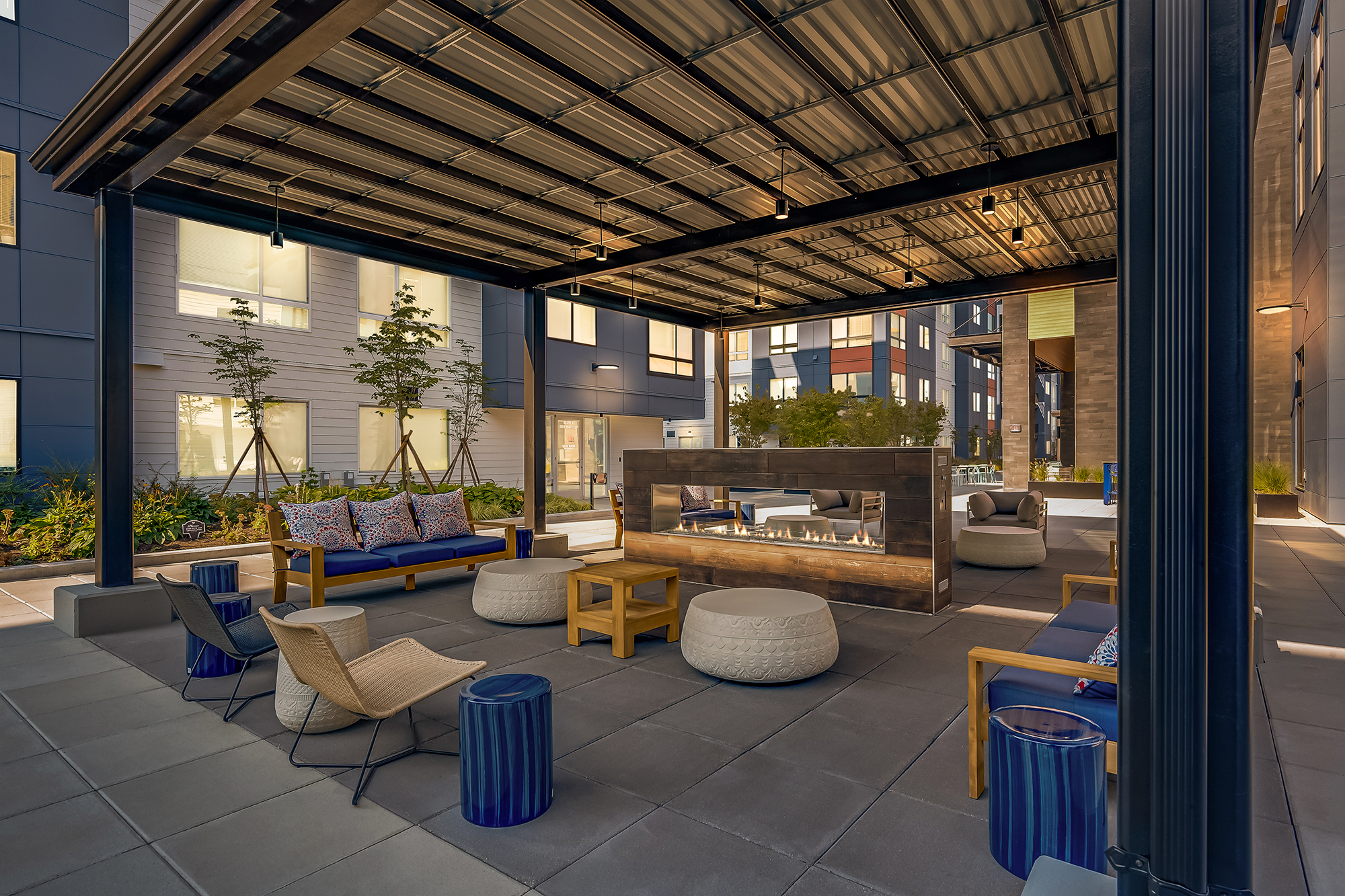 Apartment building outdoor lounge area with a fire pit at The Woods at Alderwood in Lynnwood, WA.