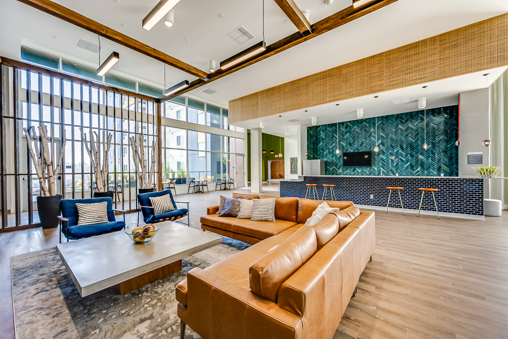 Resident clubhouse with TV and multiple seating options at The Woods at Alderwood in Lynnwood, WA.
